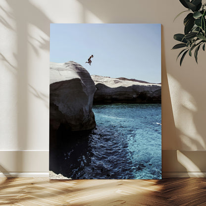 Canvas of a cliff diver above turquoise waters and rocky coastline under clear sky, ideal for adventurous minimalist or coastal home decor.