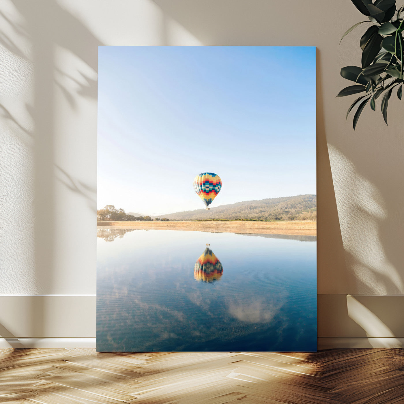Canvas of a hot air balloon floating above a calm lake with soft reflections and vibrant sky, ideal for modern minimalist or adventure-themed home decor.