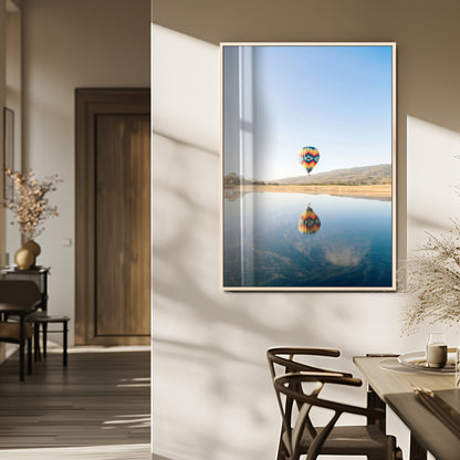 Canvas of a hot air balloon floating above a calm lake with soft reflections and vibrant sky, ideal for modern minimalist or adventure-themed home decor.