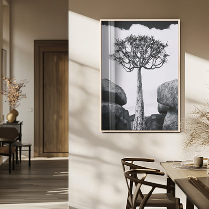 Tall desert tree in black and white, standing between large rocks, perfect for bold and minimalist nature-themed interior spaces.