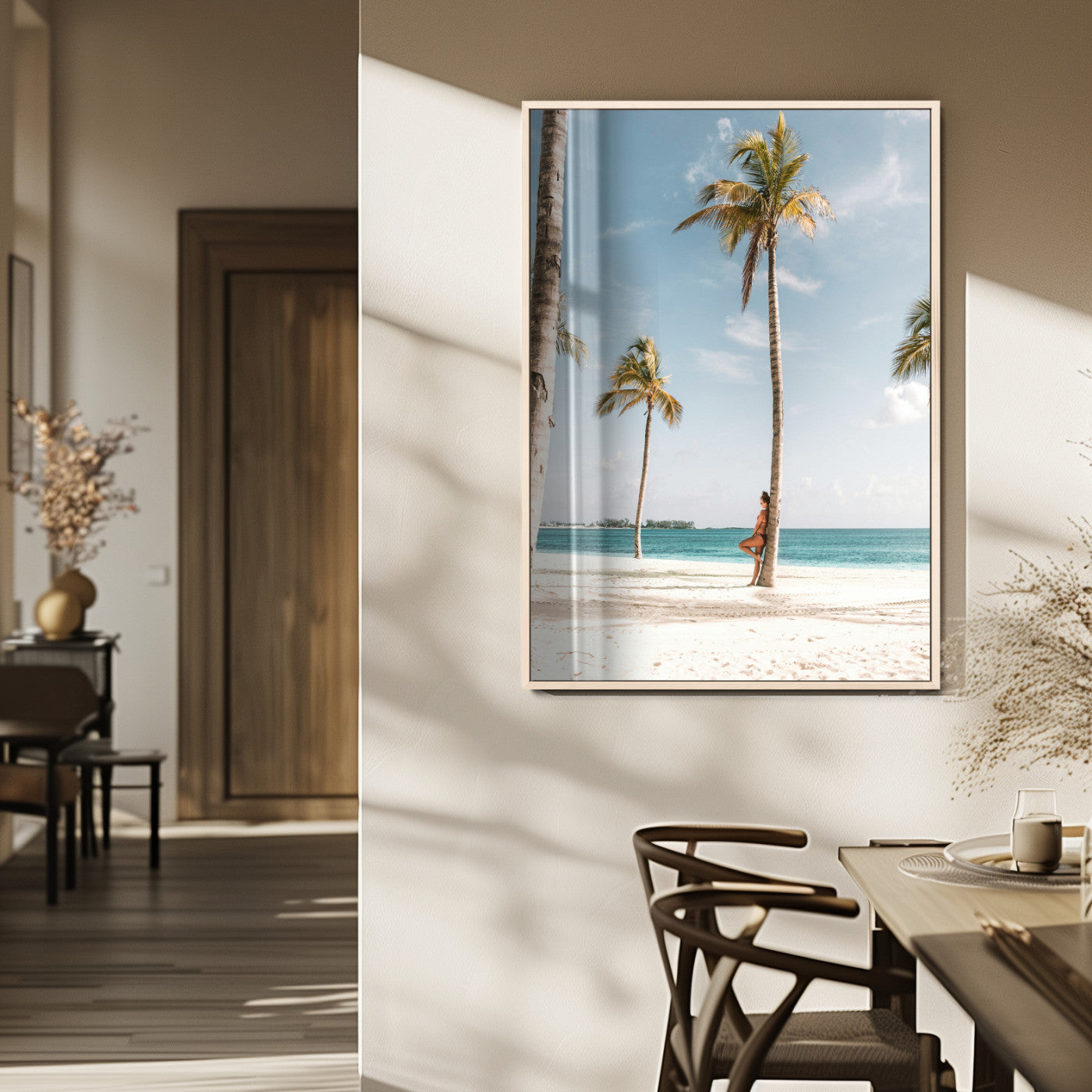 Person leaning on a palm tree at a tropical beach with white sand and turquoise water, perfect for coastal or beach-themed home decor.