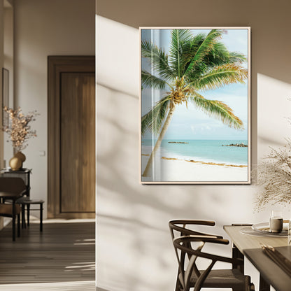 A tall palm tree leaning over a white sandy beach with turquoise ocean waves, creating a peaceful and tropical coastal scene.