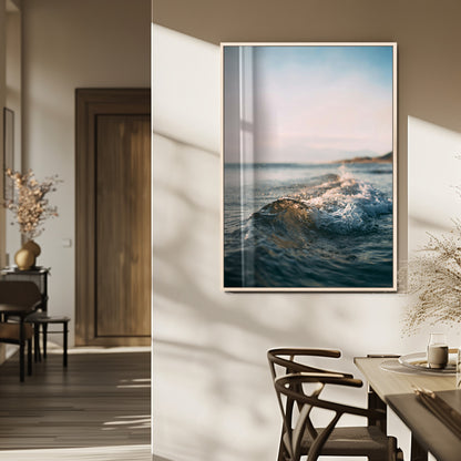 Close-up of ocean waves rolling gently toward the shore at sunset, creating a peaceful and minimalist coastal scene.