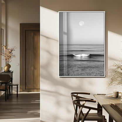 Black and white wall art of a calm ocean wave beneath a full moon, ideal for minimalist or monochrome coastal decor.