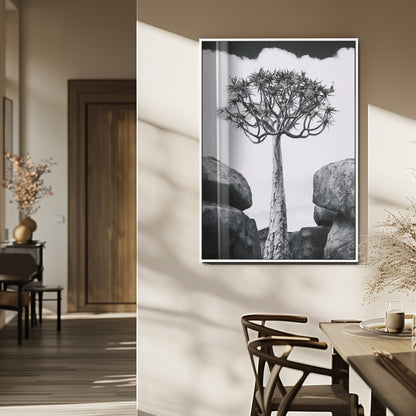Tall desert tree in black and white, standing between large rocks, perfect for bold and minimalist nature-themed interior spaces.