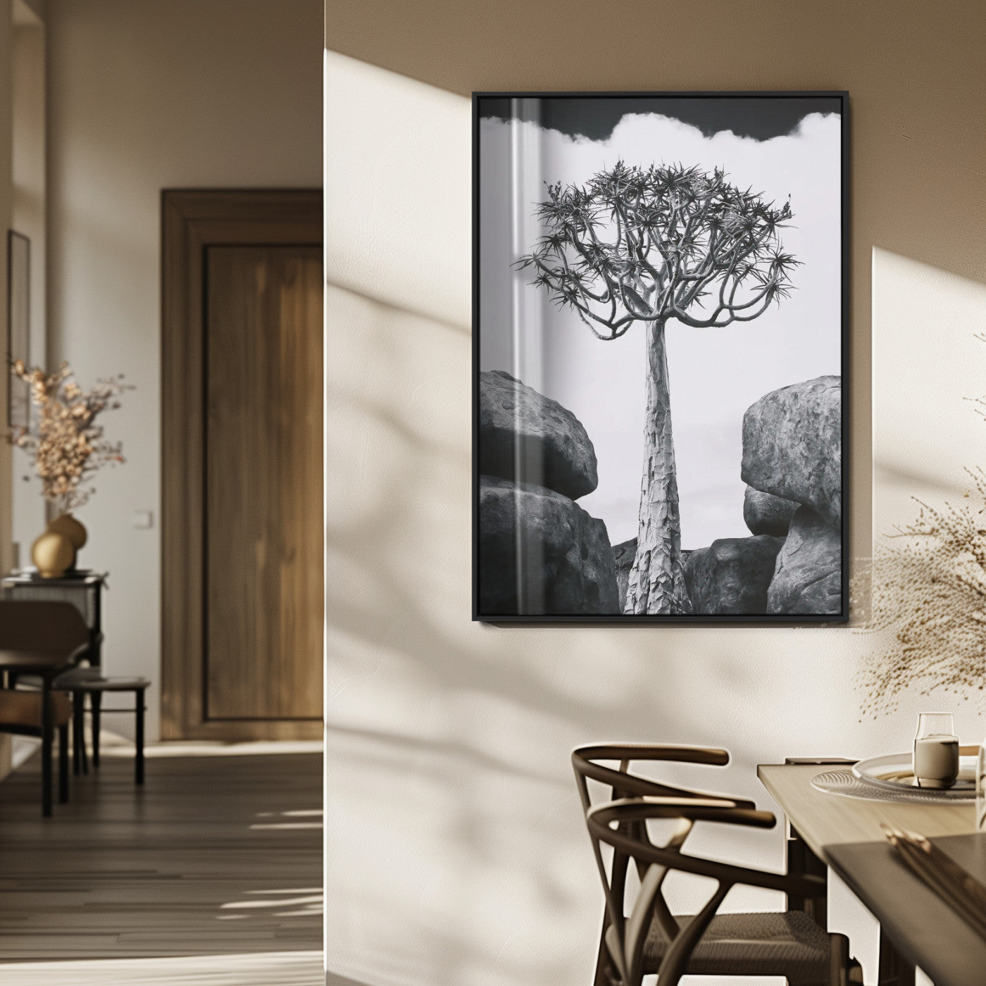 Tall desert tree in black and white, standing between large rocks, perfect for bold and minimalist nature-themed interior spaces.