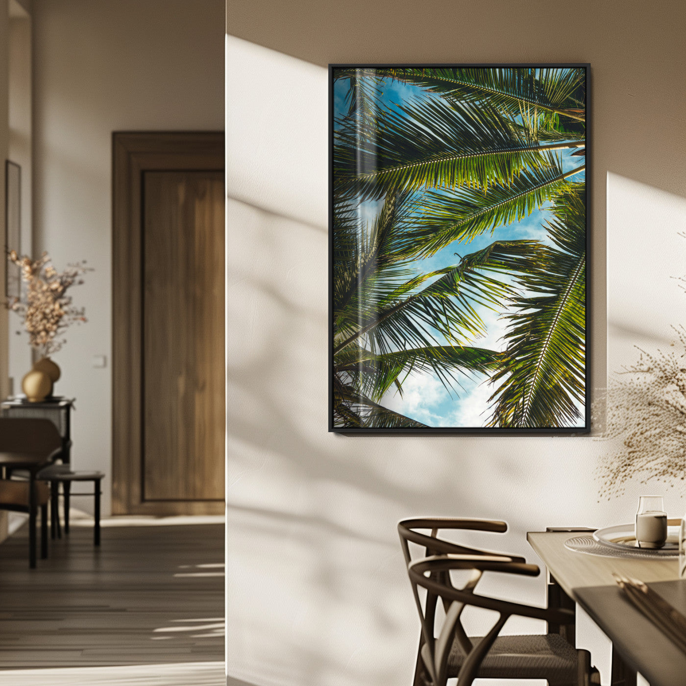 Looking up at lush green palm leaves against a bright blue sky, creating a tropical and relaxing coastal aesthetic.