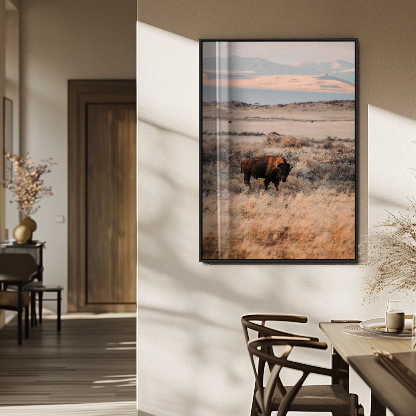 A solitary bison standing in golden prairie grass with distant mountains and soft sunset light, ideal for rustic, lodge, and western decor.