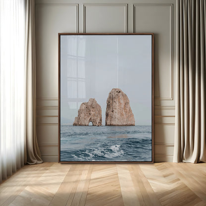 Serene photograph of the Faraglioni rocks in Capri with calm blue waters, perfect for Mediterranean coastal or minimalist travel-themed decor.