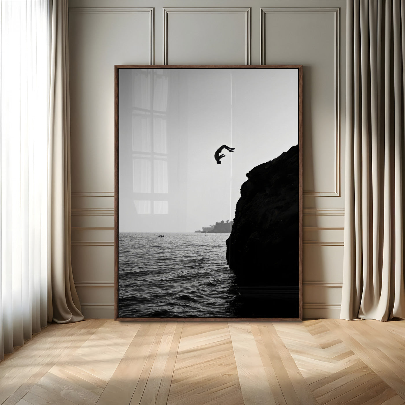 Silhouette of a person mid-air during a cliff jump over the ocean, captured in black and white for minimalist adventure decor.