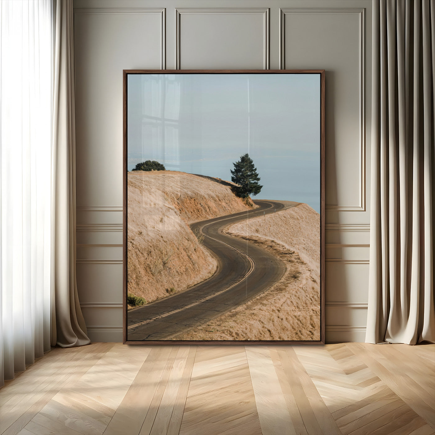 Earth-toned photograph of a winding road through golden hills, ideal for neutral or rustic-themed decor with a calming travel vibe.