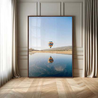 Canvas of a hot air balloon floating above a calm lake with soft reflections and vibrant sky, ideal for modern minimalist or adventure-themed home decor.