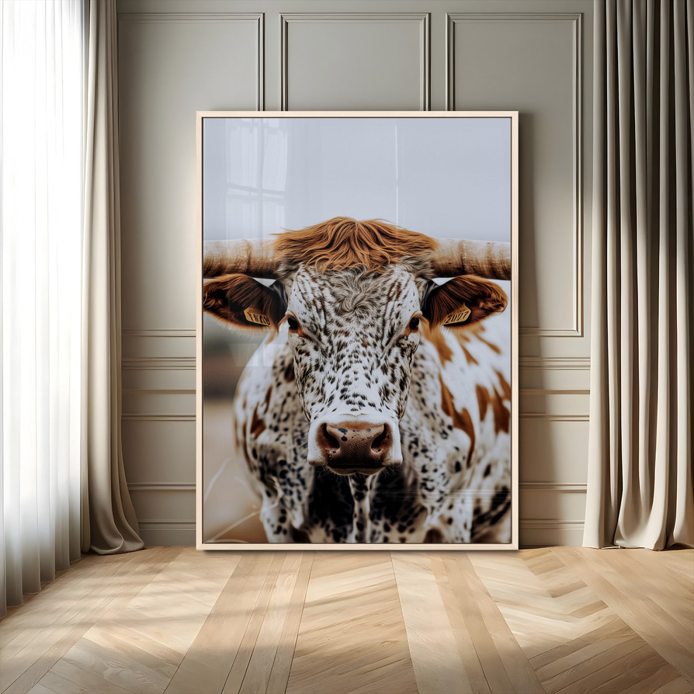 Close-up of a speckled Texas longhorn with wide horns and a bold gaze, perfect for rustic or country-style decor in warm tones.
