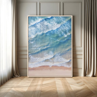 Aerial photo of soft blue waves meeting sandy shore, perfect for modern coastal or beach-themed decor with a light and tranquil aesthetic.