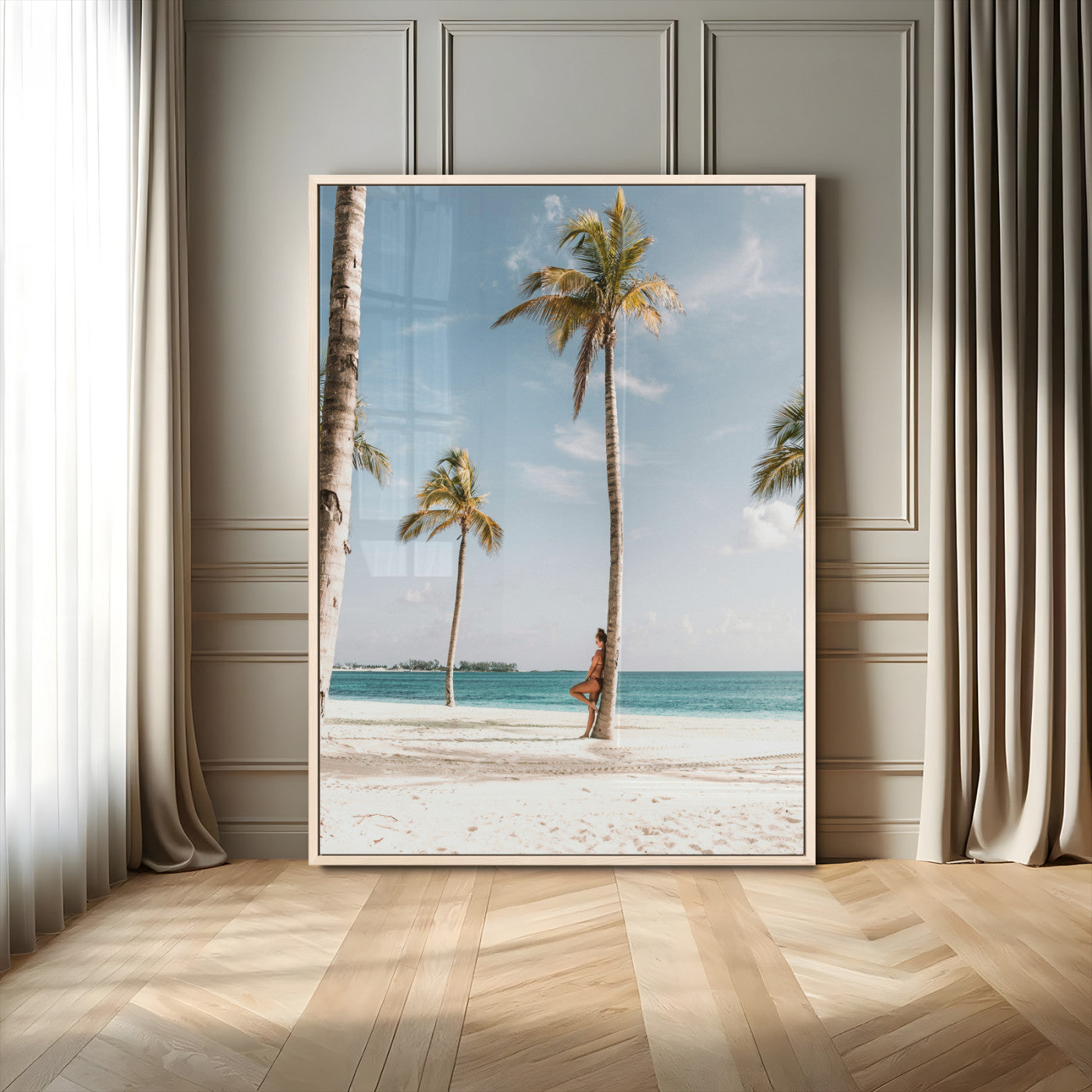 Person leaning on a palm tree at a tropical beach with white sand and turquoise water, perfect for coastal or beach-themed home decor.