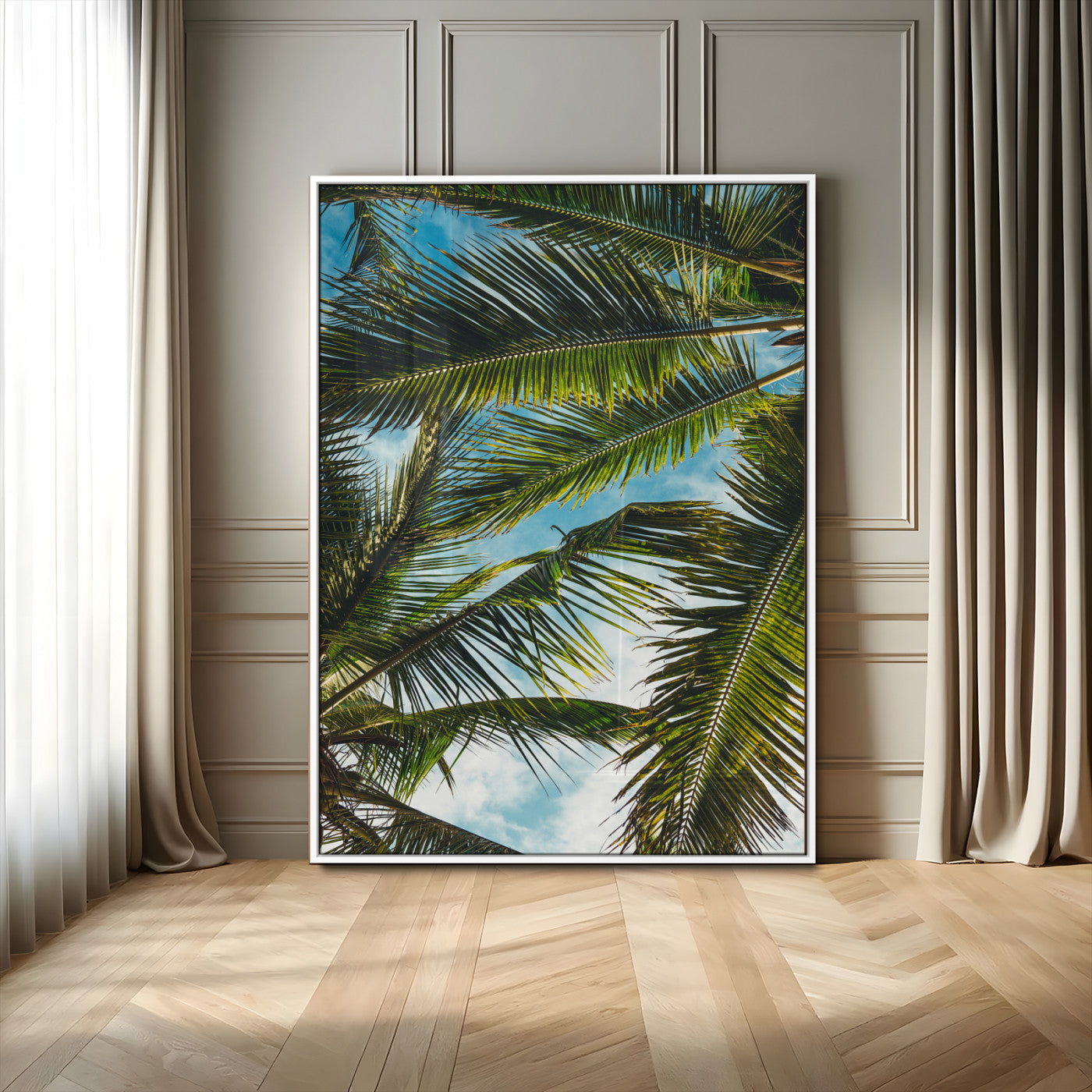 Looking up at lush green palm leaves against a bright blue sky, creating a tropical and relaxing coastal aesthetic.