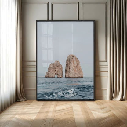 Serene photograph of the Faraglioni rocks in Capri with calm blue waters, perfect for Mediterranean coastal or minimalist travel-themed decor.