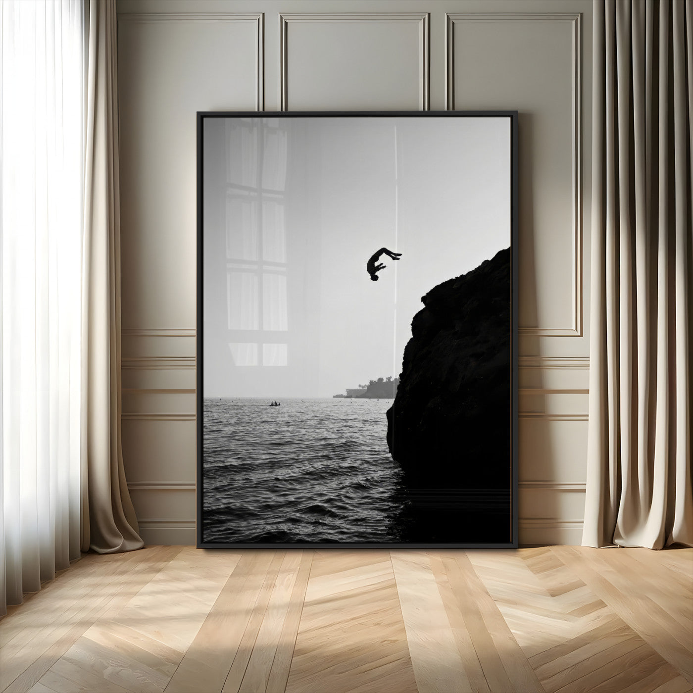 Silhouette of a person mid-air during a cliff jump over the ocean, captured in black and white for minimalist adventure decor.