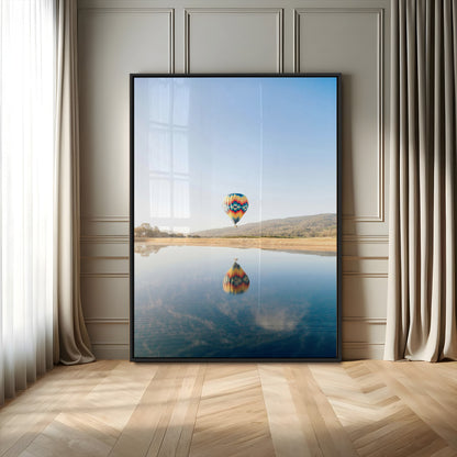 Canvas of a hot air balloon floating above a calm lake with soft reflections and vibrant sky, ideal for modern minimalist or adventure-themed home decor.