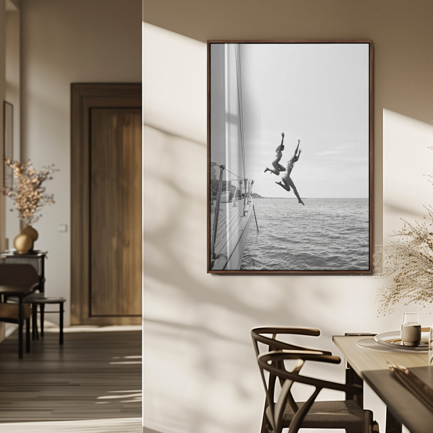 Black and white canvas wall art of two women joyfully jumping off a yacht into the sea, ideal for minimalist coastal or nautical-themed spaces.