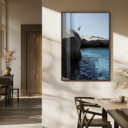 Canvas of a cliff diver above turquoise waters and rocky coastline under clear sky, ideal for adventurous minimalist or coastal home decor.