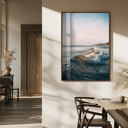 Close-up of ocean waves rolling gently toward the shore at sunset, creating a peaceful and minimalist coastal scene.