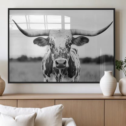 Capture the strength and elegance of nature with this striking black and white portrait of a longhorn cow. Its powerful presence makes a bold statement in any room.