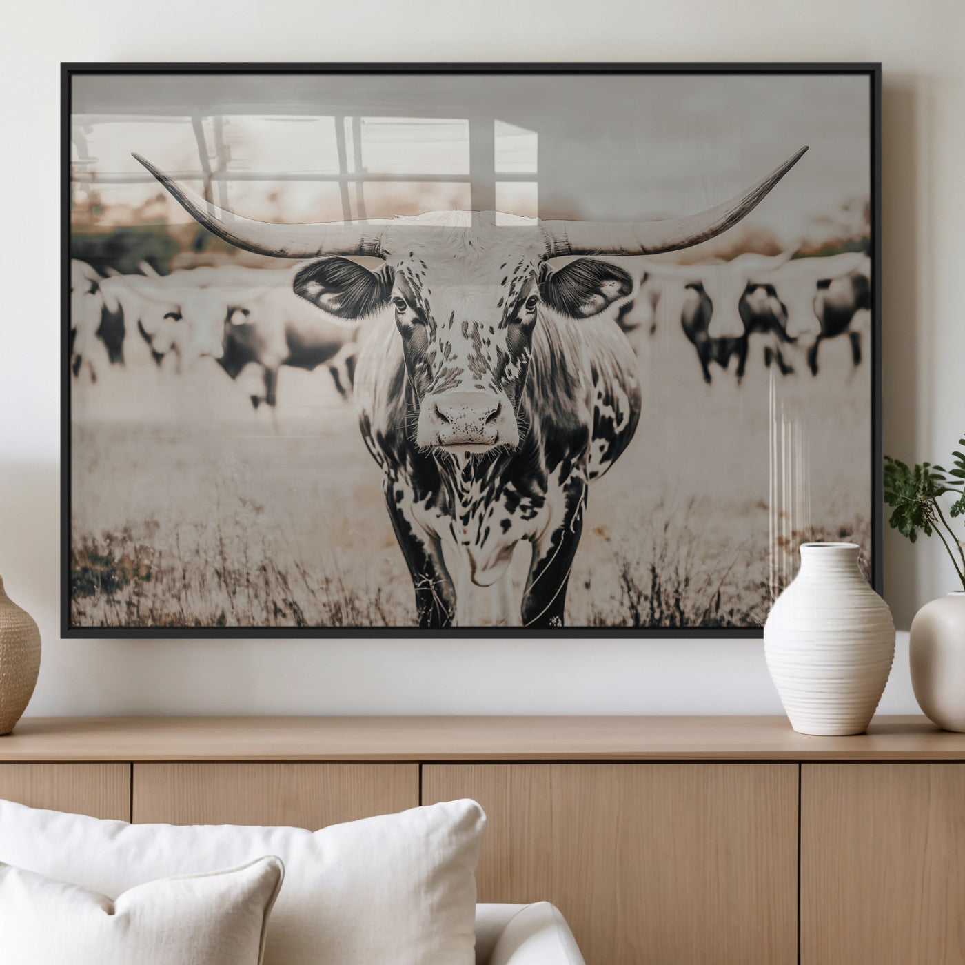 Canvas of a speckled Texas longhorn standing boldly in a field with a herd behind, perfect for rustic western or farmhouse wall decor.