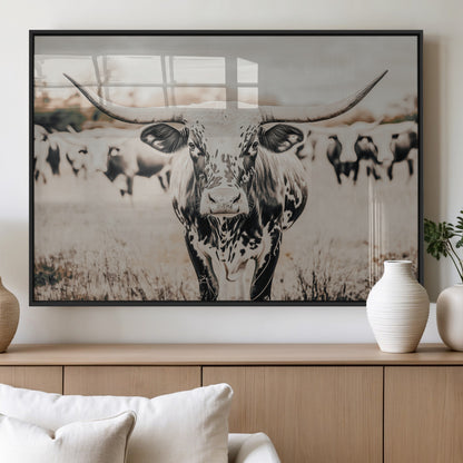 Canvas of a speckled Texas longhorn standing boldly in a field with a herd behind, perfect for rustic western or farmhouse wall decor.