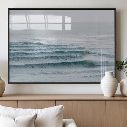 High-angle view of surfers lining up across layered ocean waves, ideal for minimal coastal or surf-inspired room decor.