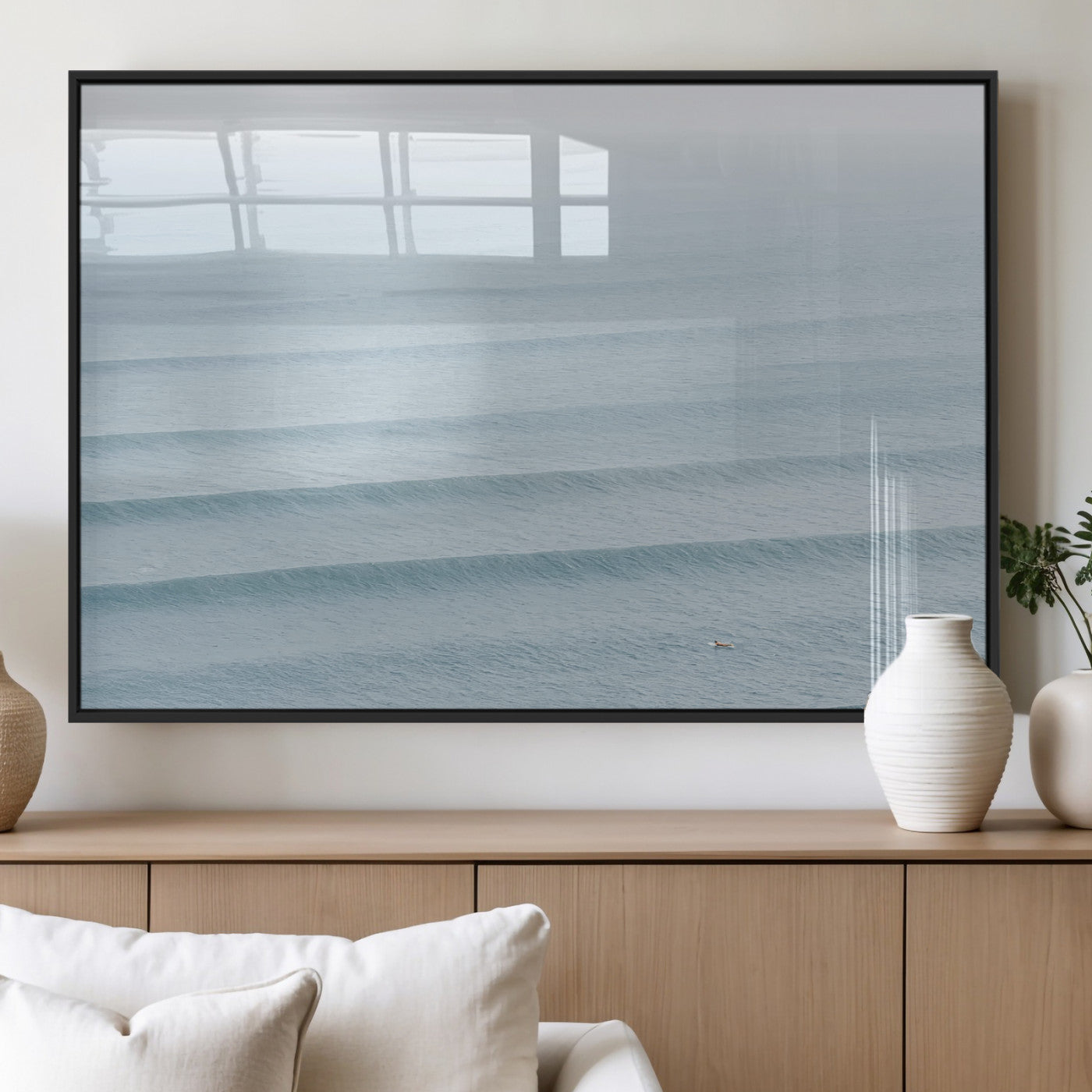 Framed canvas of repeating ocean waves with a distant solo surfer, ideal for minimalist ocean or calm coastal wall decor.