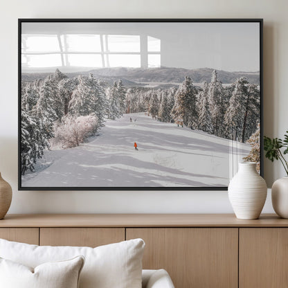 Bright ski trail lined with snow-covered pines and a skier in orange, perfect for alpine adventure or winter sports-inspired decor.