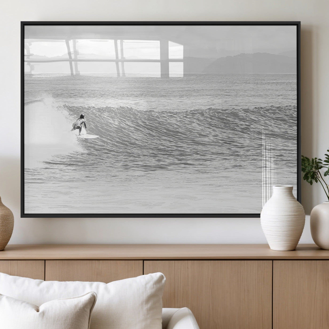 Monochrome photo of a surfer riding a wave with distant mountains, ideal for coastal motion or black and white surf-themed wall decor.