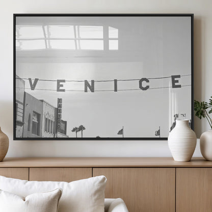Black and white photo of Venice Beach sign and palm-lined street, perfect for urban coastal or minimalist LA-inspired wall decoration.