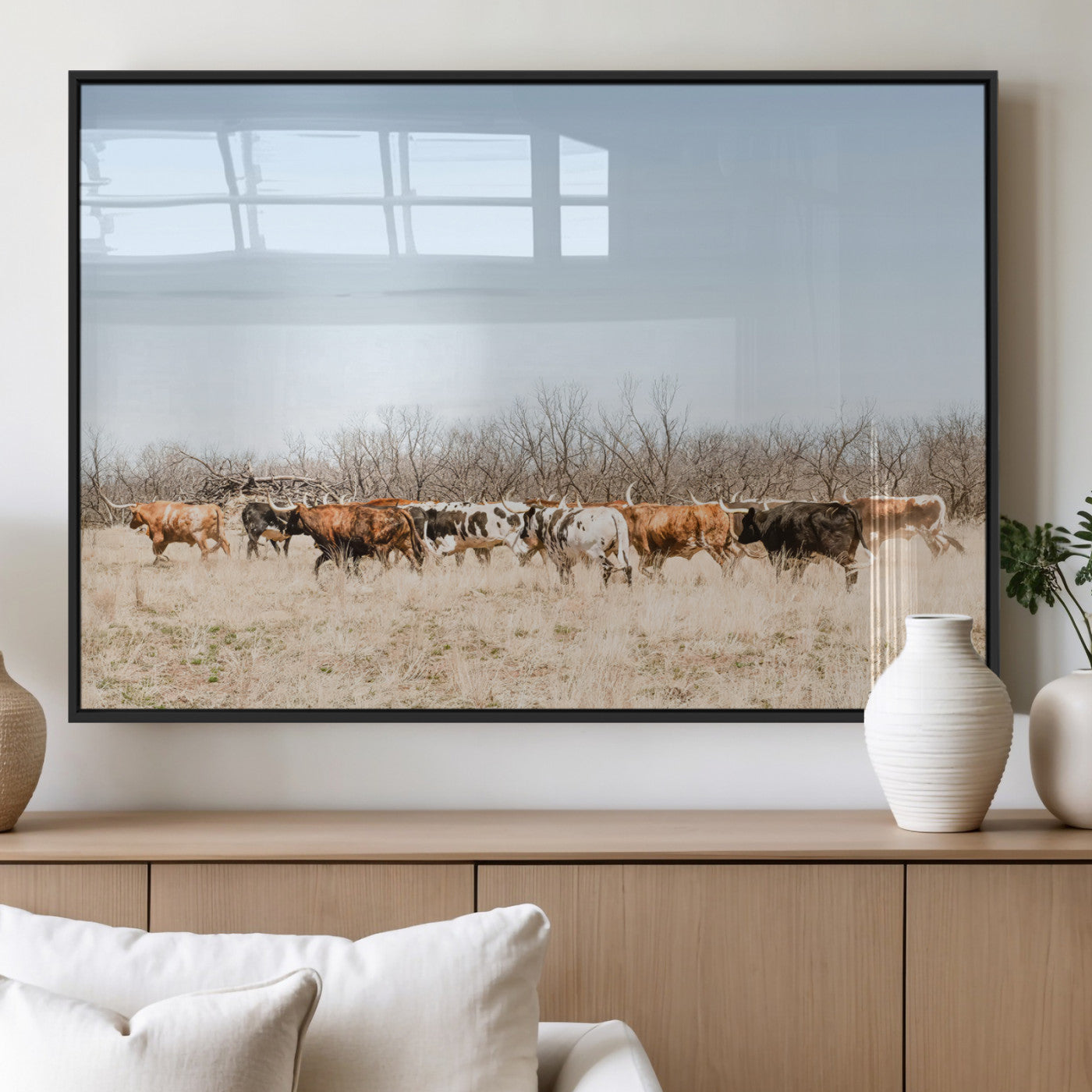 Framed wall art of Texas longhorn cattle walking through a dry, neutral-toned prairie, perfect for rustic farmhouse or western-themed home decor.