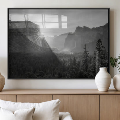 Black and white landscape of Yosemite with sun rays peeking over El Capitan, ideal for moody nature or modern rustic decor.