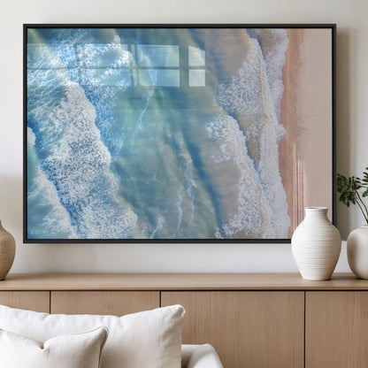 Aerial photo of soft blue waves meeting sandy shore, perfect for modern coastal or beach-themed decor with a light and tranquil aesthetic.