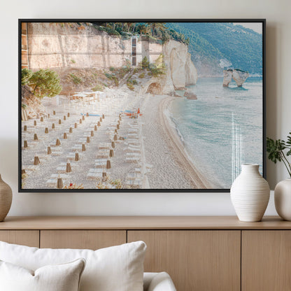 Wall art of a calm Mediterranean beach with rows of sun loungers and umbrellas in soft pastel tones, perfect for light coastal or vacation-themed decor.