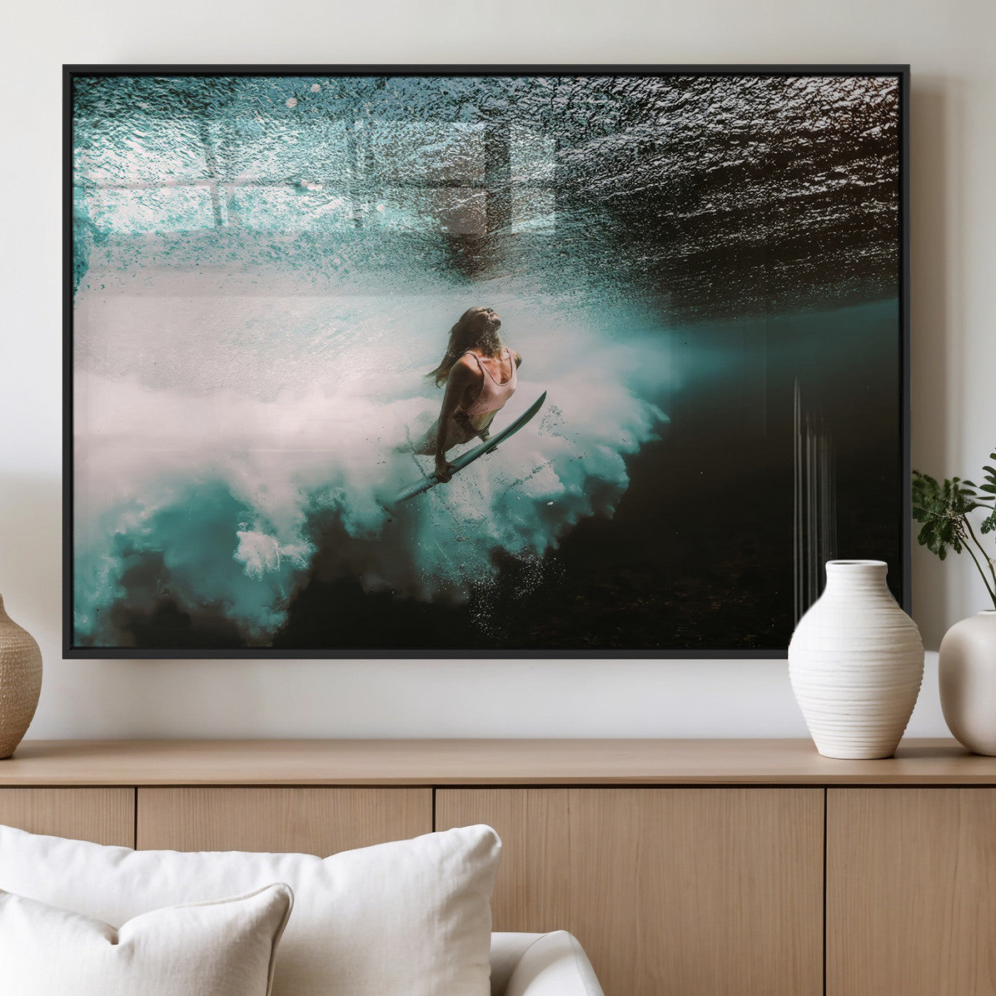 Vibrant underwater photo of a female surfer diving through turquoise waves, perfect for coastal boho or surf-inspired home decor.