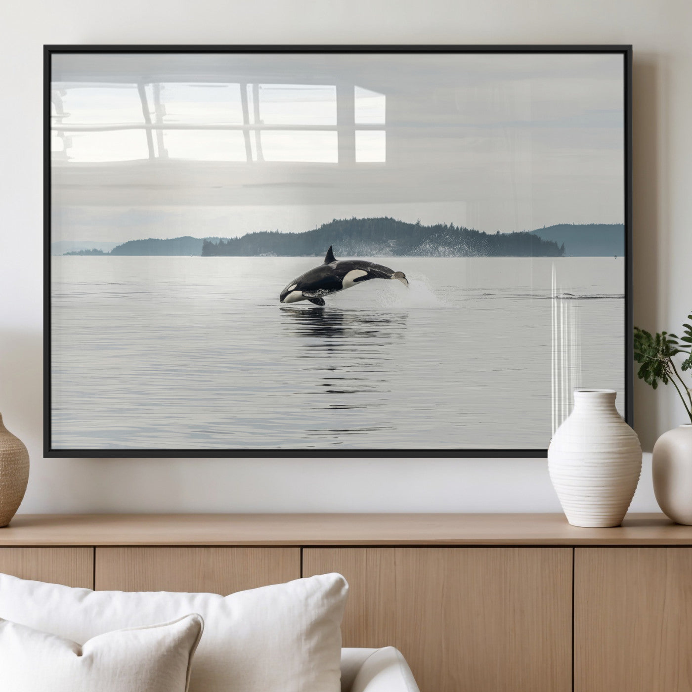 An orca jumping out of calm ocean waters with a misty island in the background, creating a serene and minimalist marine wildlife scene.