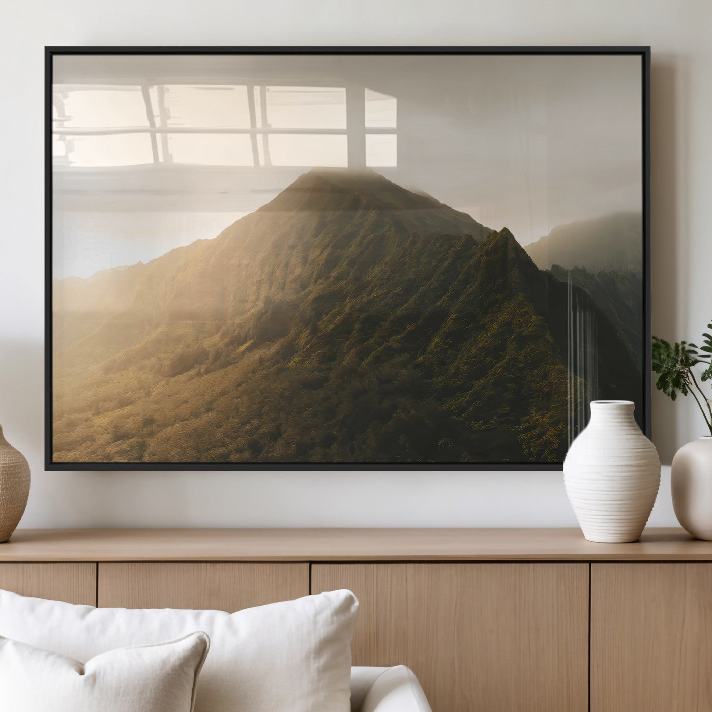 Sunlit mountain peak with mist rolling over its rugged slopes, bathed in golden light, creating a warm and tranquil nature-inspired scene.