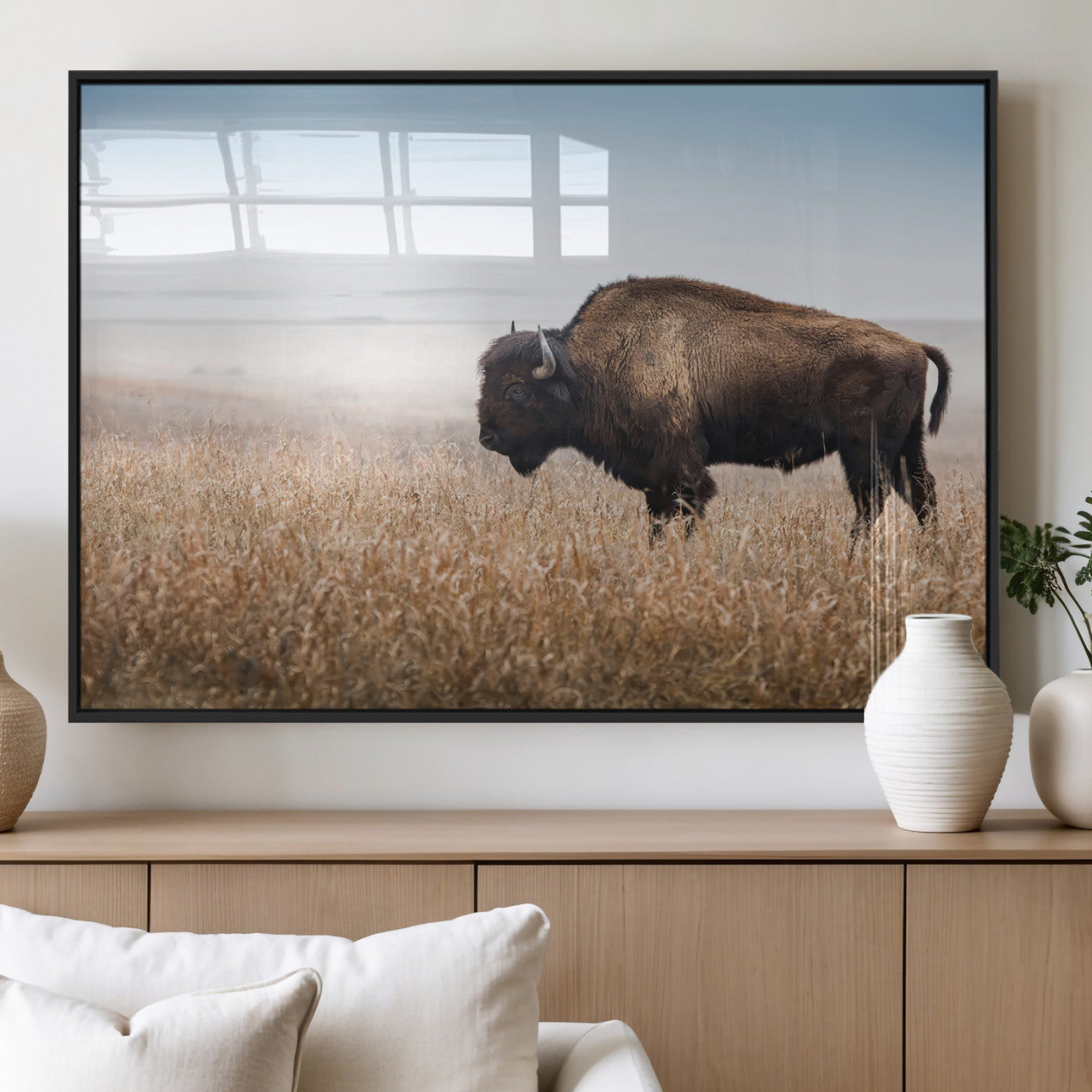 A majestic bison standing in an open prairie field, its strong form blending into the golden grass under a vast blue sky, evoking the wild spirit of the American plains.