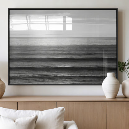 Minimalist black and white ocean view with layered waves reflecting sunlight, evoking a sense of calm and coastal serenity.