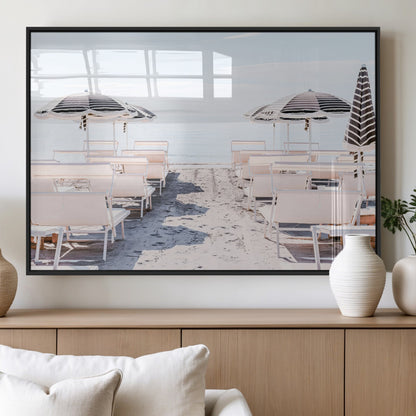 A serene minimalist beach scene featuring striped umbrellas, soft pastel sand, and an elegant lounge setup, creating a tranquil and stylish coastal retreat.