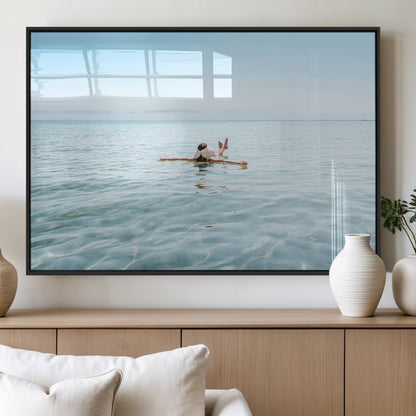A peaceful minimalist scene of a person floating on crystal-clear water, surrounded by a vast open horizon, capturing relaxation and serenity in a tranquil aquatic setting.