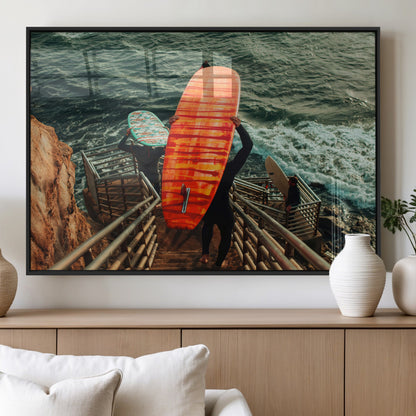 A surfer carrying a bold orange surfboard down a rugged staircase toward the ocean, bathed in golden hour light, capturing the energy of coastal adventure.