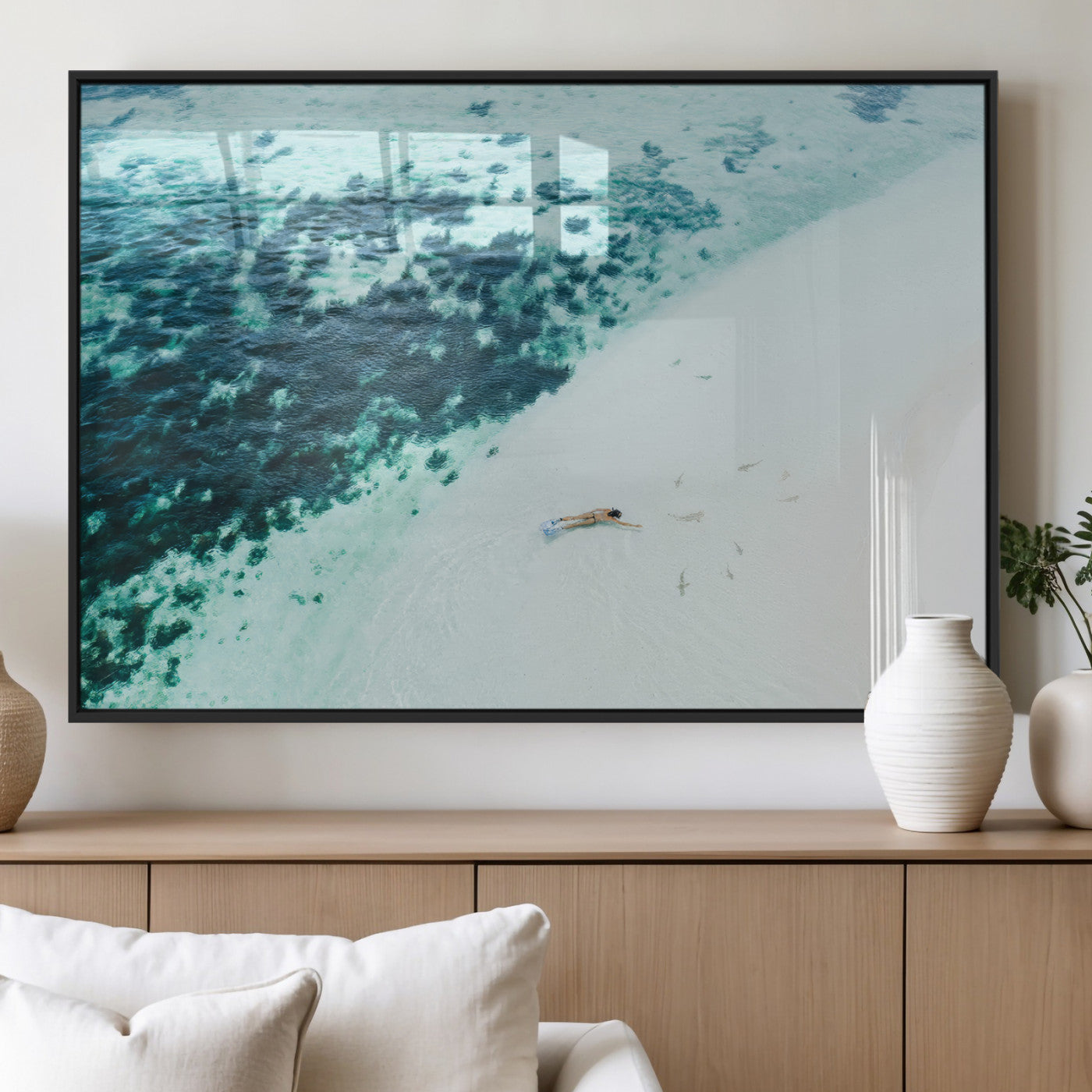Canvas featuring an aerial view of a swimmer in shallow turquoise waters with coral patterns, ideal for tropical coastal home decor.