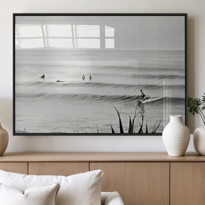 Monochrome canvas of surfers on calm ocean waves, ideal for minimalist coastal or beach-inspired interior decor.