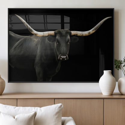Close-up of a black Texas longhorn with large curved horns on black background, ideal for rustic farmhouse or modern western interiors.