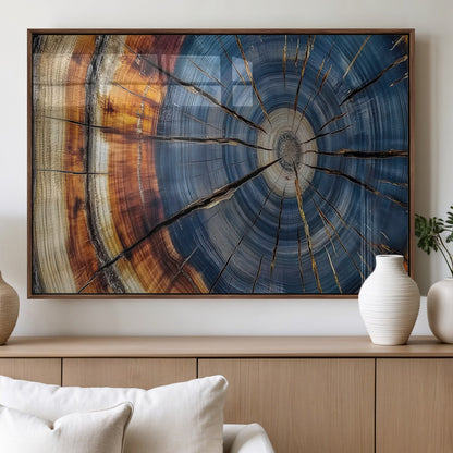 A stunning close-up view of a tree trunk, showcasing the intricate growth rings in a vibrant mix of warm browns, cool blues, and hints of natural texture.